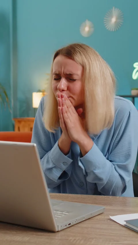 Upset woman with hands joined at web camera of laptop compute asking more time Stock Footage 347055747