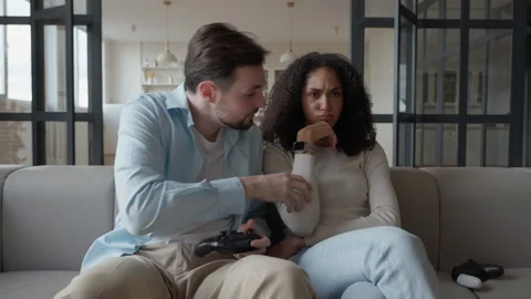 Upset Woman Refusing To Play After Losing, Sitting Next To Boyfriend On Couch Stock Footage 306697695