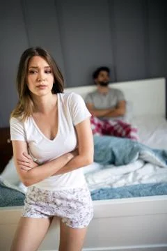 Upset young couple having problems with sex. Stock Photos