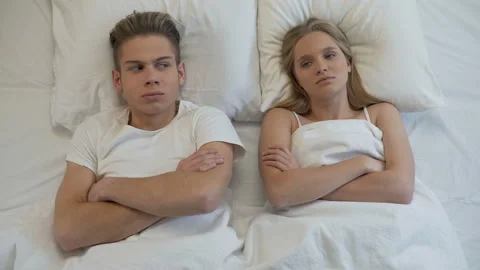 Upset young couple lying in bed, sexual problems, relations misunderstanding 動画素材 86812126
