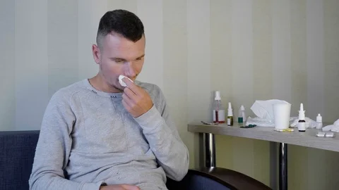 A upset young guy is sitting on the couch Stock Footage 116030210