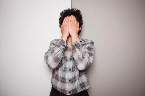 Upset young man against dual colored background 스톡 사진