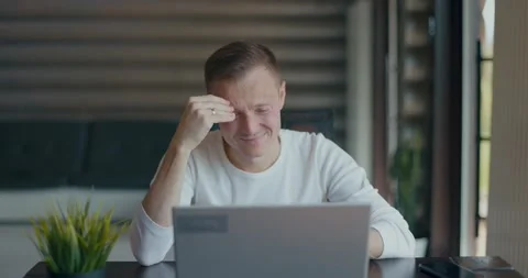 Upset young man covering face with palm in despair after reading bad news on Stock Footage 197816342