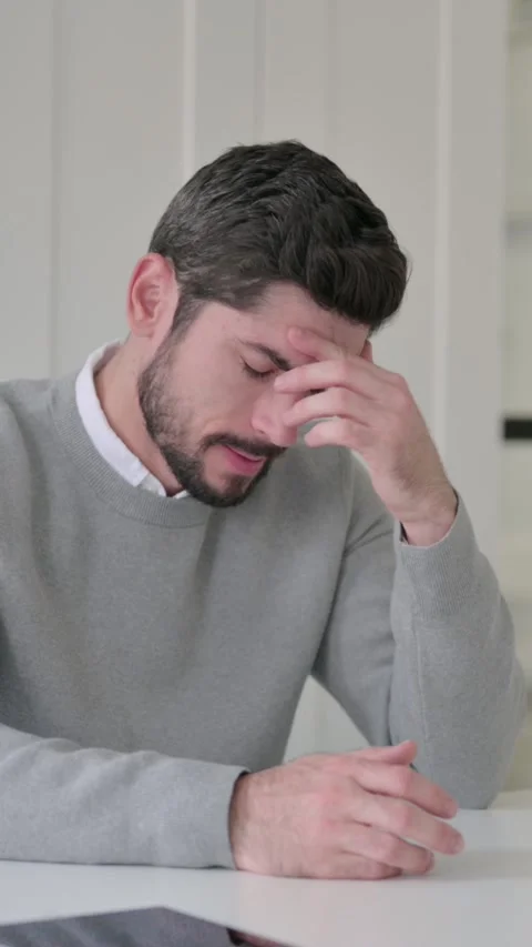 Upset Young Man Feeling Worried While Sitting in Office, Vertical Video Stock Footage 339582338