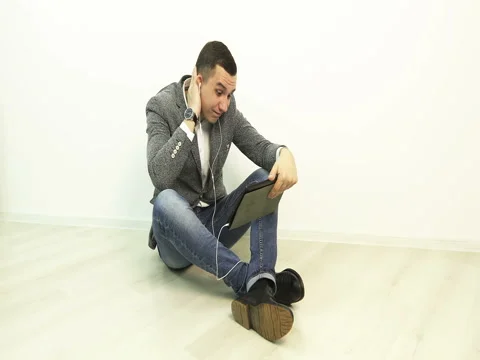 Upset young man finished the conversation by video call on the tablet. Stock Footage 73779334