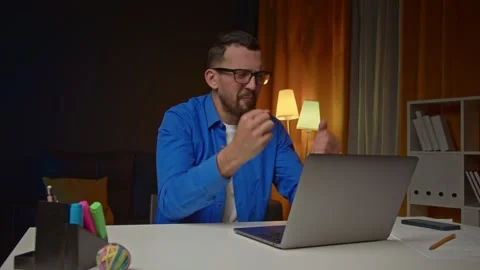 Upset Young Man Gesticulates In Anger, While Getting Bad News from Reading Bad Stock Footage 170132946