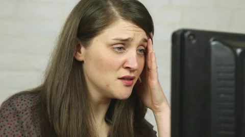 Upset young married woman crying at computer monitor Stock Footage