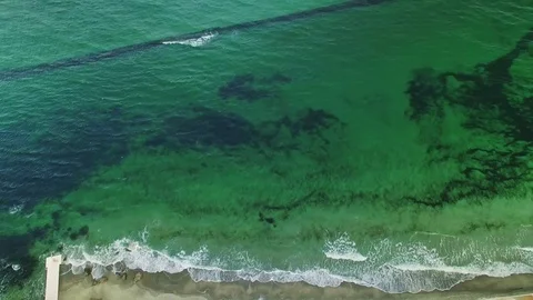 Upside down aerial of green colored sea and coastline Stock Footage 73927279