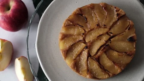 Upside-Down Apple Cake set on white cafe table. Stock Footage 146954520