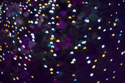 Upside down blur heart shape love valentine day night light on tree in garden Stock Photos