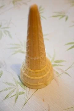 Upside-down empty ice cream cone on table 스톡 사진