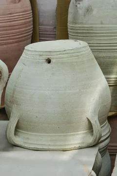 Upside down grey terracotta flower pot with handles Photos