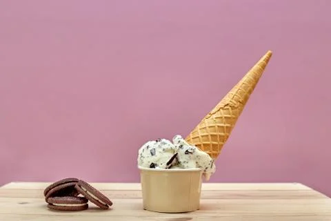 Upside down ice cream container on a pink background. Stock Photos