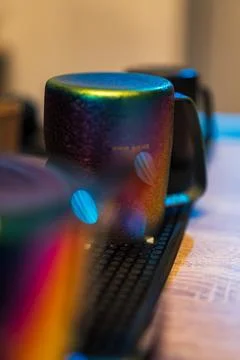 Upside down iridescent ceramic mug on rubber mat in warm light Stock Photos