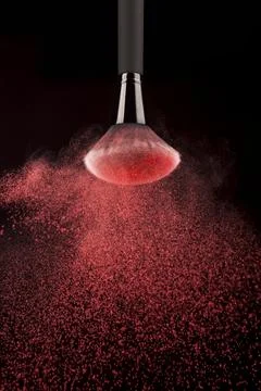 Upside down makeup brush red powder splash Stock Photos