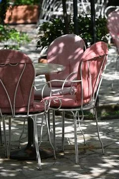 Upside-Down Outdoor Cafe Table and Pink Chairs Stock Photos