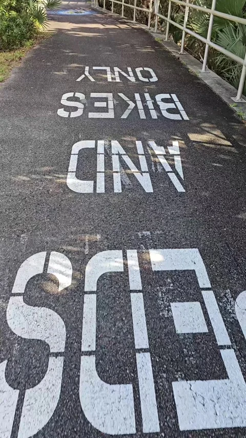 Upside down peds and bikes only sign walking motion perspective vertical video Stock Footage 330552272