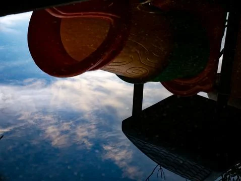 Upside Down Reflection of Colorful Playground Slide in Rain Puddle, Abstrac.. Stock Photos