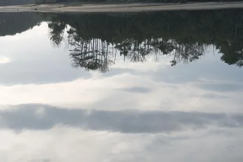 Upside Down Sky and Trees Reflection on Lake Port d’Albret Stock Photos