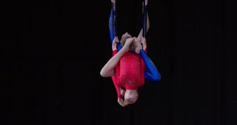 Upside down spin in the air by aerial gymnasts on stage, tournament, 4k Stock Footage 156891222