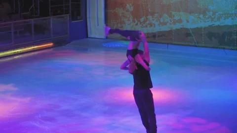 Upside down spin element by skaters couple on ice arena Stock-Footage 137456041