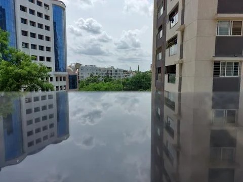 Upside down view of bright blue sky and buildings reflection Stock Photos