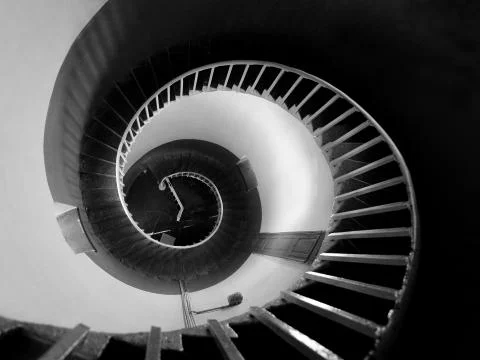 Upside view into the spiral of a lighthouse Stock Photos