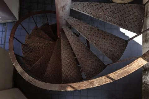 Upside view of a spiral staircase pattern. Spiral stairs circle in old cour.. Stock Photos