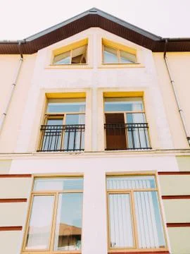 The upside view of the yellow house with open window. Stock Photos
