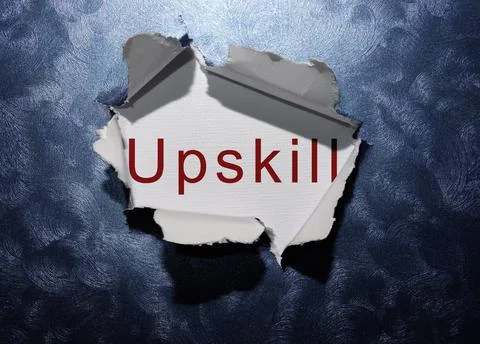 Upskill text revealed in ripped blue paper background Stock Photos