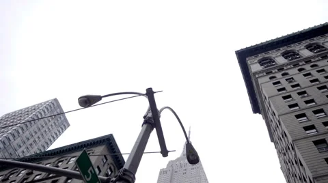 Upward angle of Empire State Building on overcast day in NYC 1080 HD Stock Footage 63837052