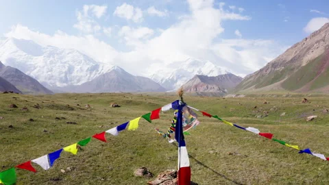Upward camera motion over sacred Puja stupa decorated with prayer flags at 3600m 動画素材 316833693