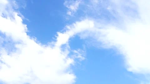 Upward camera motion through fluffy white clouds in a blue summer sky Stock Footage 312758115