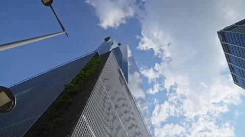 Upward camera movement between modern skyscrapers and office buildings Video stock 335728374