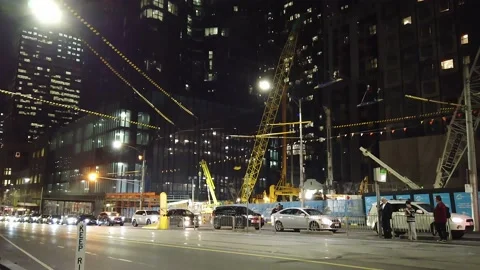 Upward camera sweep of vehicle traffic, modern buildings and construction work Stock Footage 140194106