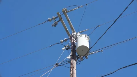 Upward Diagonal View of Telephone Pole Against Blue Sky Stock Footage 291938611
