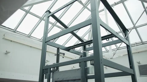 Upward low-angle view of dark steel framework with vertical posts, crossbeams Stock Footage 348263076