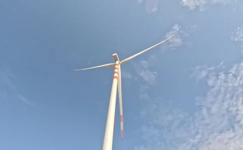 Upward Low Angle View of Industrial Wind Turbine Tower and Power Lines Under Stock Footage 342775544