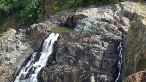 Upward Pan of Massive Waterfall in Lush Natural Landscape Stock Footage 314948492