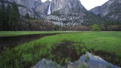 Upward pan: reflection and view of Upper Yosemite Falls from Yosemite Valley Stock Footage 241194128