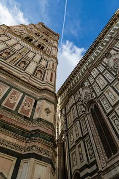 This upward perspective captures Giotto's Bell Tower and part of the Florence Stock Photos