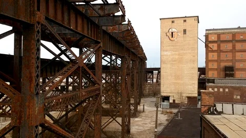 Upward tracking shot over train tracks and grain storage building Stock Footage 104876118