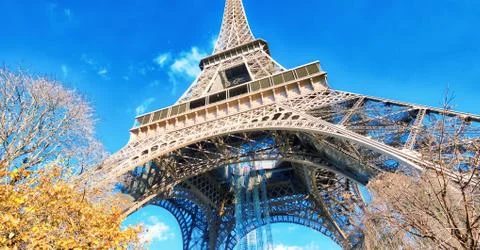 Upward view of Eiffel Tower on a beautiful sunny winter day - Paris - France Stock Photos