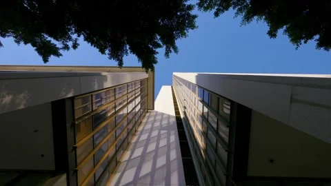 Upward view of modern skyscraper with a dynamic perspective in 4k Stock Footage 281471293