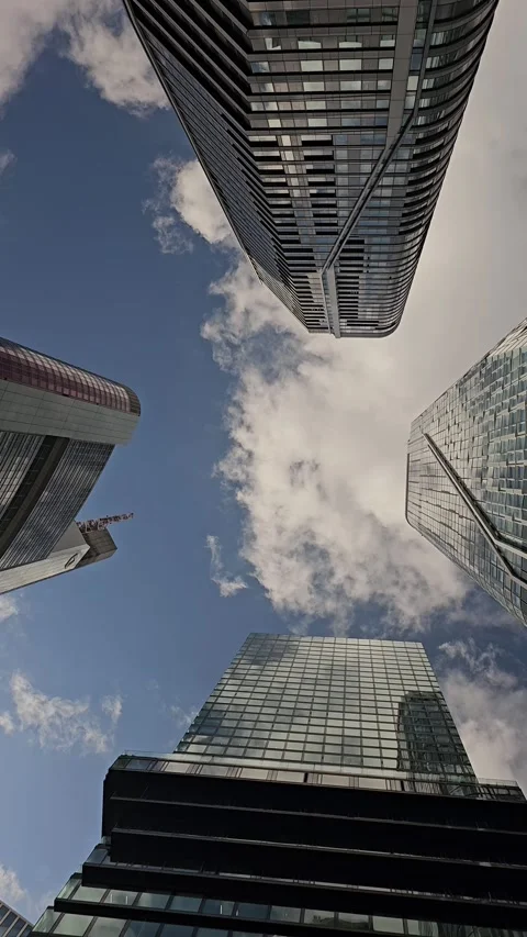 Upward View of Modern Skyscrapers Framing Blue Sky Stock Footage 344310118