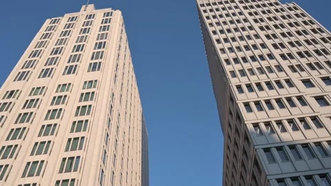 Upward View Panning Between Two Modern Skyscrapers on a Sunny Day with Blue Sky Stock Footage 319670214