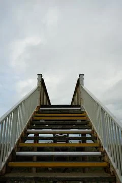 Upward View Of Rustic Pedestrian Bridge Staircase, White Railings, Towyn, North Stock Photos