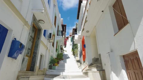 Upward view of sunlit, narrow, stepped street in Skopelos town, Greece. Classic Stock Footage 346671182