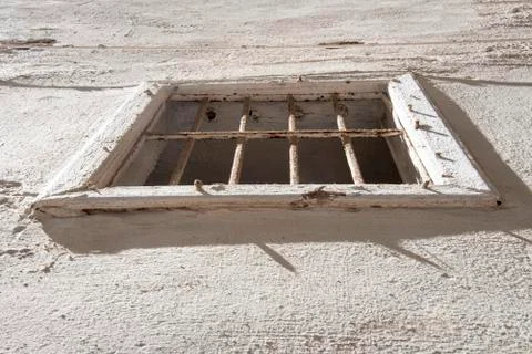 Upward view of a white window frame with a security grid in a white wall Stock Photos