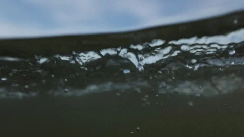 Upwards POV just under sea surface seeing bits of blue sky Stock Footage 340382425